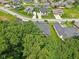 Neighborhood aerial view surrounded by mature trees, showing well-maintained lawns and landscaping at 5572 Harness Dr, Greenwood, IN 46143