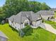 Aerial view of a home with lush lawn, mature landscaping, and neutral brick exterior at 5572 Harness Dr, Greenwood, IN 46143