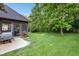 The backyard features a screened-in porch with an outdoor grill on a plush, green lawn at 5572 Harness Dr, Greenwood, IN 46143