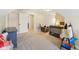 Large carpeted bedroom featuring closet, a cozy chair, bed, and desk at 5572 Harness Dr, Greenwood, IN 46143