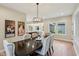 Dining room featuring a dark wood table, upholstered chairs and an open concept to the kitchen at 5572 Harness Dr, Greenwood, IN 46143