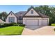 Charming two-story home with brick exterior, well-manicured lawn, and attached three car garage at 5572 Harness Dr, Greenwood, IN 46143