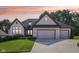 Charming two-story home with brick exterior, well-manicured lawn, and attached three car garage at 5572 Harness Dr, Greenwood, IN 46143