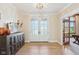 Stylish foyer featuring hardwood floors, shiplap accent wall, and elegant double doors at 5572 Harness Dr, Greenwood, IN 46143
