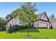 Charming brick home featuring a well-manicured lawn and professionally landscaped yard, including mature tree at 5572 Harness Dr, Greenwood, IN 46143