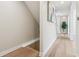 Bright hallway featuring light wood floors, a stairwell, and ample natural light at 5572 Harness Dr, Greenwood, IN 46143