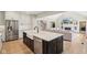 Kitchen featuring an island with sink, stainless steel appliances, and open layout to living room at 5572 Harness Dr, Greenwood, IN 46143