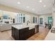 Open concept kitchen and living room featuring a kitchen island with a farmhouse sink at 5572 Harness Dr, Greenwood, IN 46143