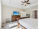 Bright main bedroom with a ceiling fan, TV, art, and a dresser for ample storage and organization at 5572 Harness Dr, Greenwood, IN 46143
