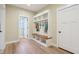 Mud room features bench with cubbies, hooks, and storage, plus hardwood flooring and light walls at 5572 Harness Dr, Greenwood, IN 46143
