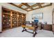 Comfortable office with custom wood built-ins, neutral color palette, and coffered ceiling at 5572 Harness Dr, Greenwood, IN 46143