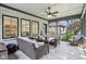 Covered outdoor patio with ceiling fan, neutral furniture, and screened in design at 5572 Harness Dr, Greenwood, IN 46143