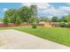 Large fenced-in backyard with a well-kept lawn, shed, and concrete patio at 5602 Northport Dr, Indianapolis, IN 46221