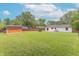 Spacious backyard features a shed, mature trees, a privacy fence, and a concrete patio at 5602 Northport Dr, Indianapolis, IN 46221