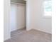 Neutral bedroom with carpet, a closet, and a window providing natural light at 5602 Northport Dr, Indianapolis, IN 46221