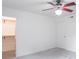 Bright bedroom with neutral carpet, ceiling fan, and a walk-in closet for ample storage at 5602 Northport Dr, Indianapolis, IN 46221