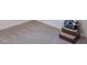 Neutral-colored carpet featuring cleaning lines and a wooden shelving unit at 5602 Northport Dr, Indianapolis, IN 46221