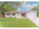 Charming home featuring a one-car garage, red shutters, and a well-maintained lawn at 5602 Northport Dr, Indianapolis, IN 46221