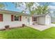 Close up of home's exterior with white siding, red shutters, and small front porch at 5602 Northport Dr, Indianapolis, IN 46221