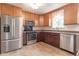 Kitchen with stainless steel appliances, ample cabinets, and a window over the sink at 5602 Northport Dr, Indianapolis, IN 46221
