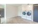 A laundry room with side-by-side washer and dryer, plus lots of storage space at 5602 Northport Dr, Indianapolis, IN 46221