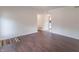 Light-filled living room with hardwood floors and a view of the entry and kitchen at 5602 Northport Dr, Indianapolis, IN 46221