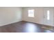 Clean, modern living room featuring hardwood floors, fresh paint, and natural light at 5602 Northport Dr, Indianapolis, IN 46221