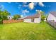 A well-maintained backyard with a lush green lawn and wood privacy fence at 5633 Fox Glove Ln, Indianapolis, IN 46254
