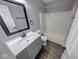 Updated bathroom features modern fixtures and a shower-tub combination at 5633 Fox Glove Ln, Indianapolis, IN 46254