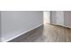 Neutral-toned bedroom featuring wood-look floors, base trim, and white doors at 5633 Fox Glove Ln, Indianapolis, IN 46254