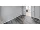 Neutral-toned bedroom with wood-look floors with entry to another room at 5633 Fox Glove Ln, Indianapolis, IN 46254