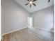 Bright bedroom boasts wood-look floors and a large window for natural light at 5633 Fox Glove Ln, Indianapolis, IN 46254
