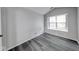 Neutral-toned bedroom featuring vaulted ceiling, wood-look floors, and a bright window at 5633 Fox Glove Ln, Indianapolis, IN 46254