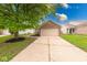 Charming brick home featuring an attached garage and a well-maintained front yard at 5633 Fox Glove Ln, Indianapolis, IN 46254