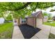 Brick home showcasing manicured landscaping, a cozy front entrance, and an attached garage at 5633 Fox Glove Ln, Indianapolis, IN 46254