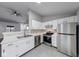 Bright kitchen featuring stainless steel appliances, white cabinetry, and updated flooring at 5633 Fox Glove Ln, Indianapolis, IN 46254