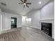 Open-concept living area with vaulted ceilings, fireplace and modern ceiling fan at 5633 Fox Glove Ln, Indianapolis, IN 46254