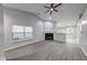 Inviting living room with a cozy fireplace, lots of natural light, and stylish flooring at 5633 Fox Glove Ln, Indianapolis, IN 46254