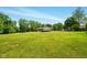 Expansive backyard featuring lush green lawn, mature trees, and ample space for outdoor activities and relaxation at 564 Penright Ct, Indianapolis, IN 46217