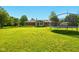 Large backyard with a sunroom, a trampoline, and a well-maintained lawn, perfect for Gathering gatherings and outdoor enjoyment at 564 Penright Ct, Indianapolis, IN 46217
