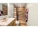 Well-lit bathroom featuring tiled shower with built-in bench and decorative accents at 564 Penright Ct, Indianapolis, IN 46217
