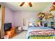 A cozy bedroom features a colorful polka dot bedspread, stuffed animals and a comfortable beanbag chair at 564 Penright Ct, Indianapolis, IN 46217