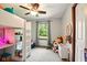 Bedroom with large window, built in desk with shelving, and lofted bed at 564 Penright Ct, Indianapolis, IN 46217