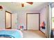 Bedroom with lilac painted walls featuring neutral carpet and a double wide closet with sliding doors at 564 Penright Ct, Indianapolis, IN 46217