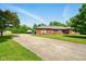 Single story brick home featuring an extra long driveway and well-maintained landscaping at 564 Penright Ct, Indianapolis, IN 46217