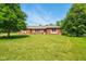 Picture of the brick home with a manicured lawn with large trees at 564 Penright Ct, Indianapolis, IN 46217