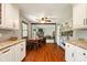 Kitchen featuring hardwood floors, white cabinets, stainless steel appliances, and eat in nook at 564 Penright Ct, Indianapolis, IN 46217