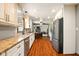 Kitchen featuring hardwood floors, white cabinets, stainless steel appliances, and open concept at 564 Penright Ct, Indianapolis, IN 46217
