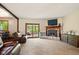 Spacious living room with a cozy stone fireplace and sliding door to a sunroom at 564 Penright Ct, Indianapolis, IN 46217