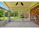 Sun room featuring large windows, neutral carpet and white walls with a brick accent wall at 564 Penright Ct, Indianapolis, IN 46217